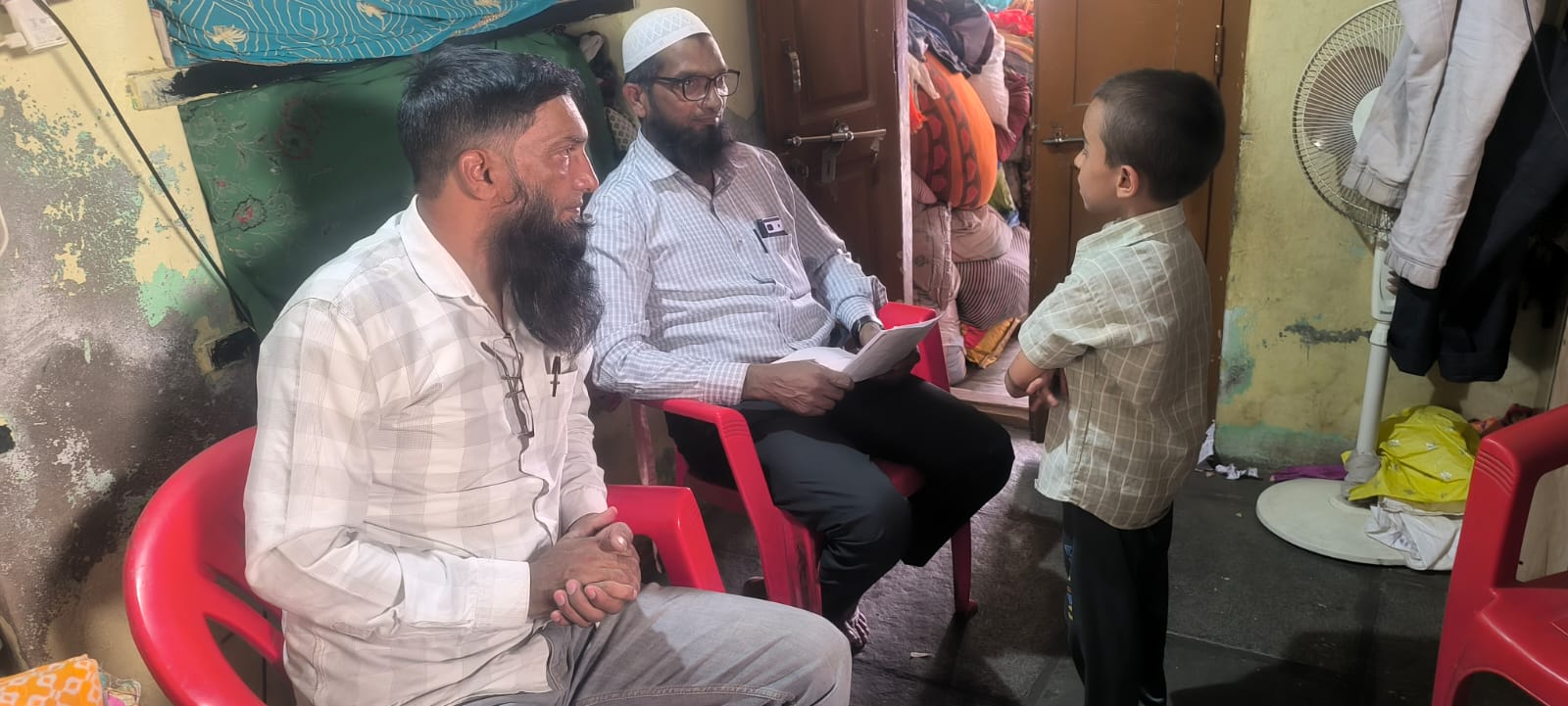 Team interacting with beneficiary family